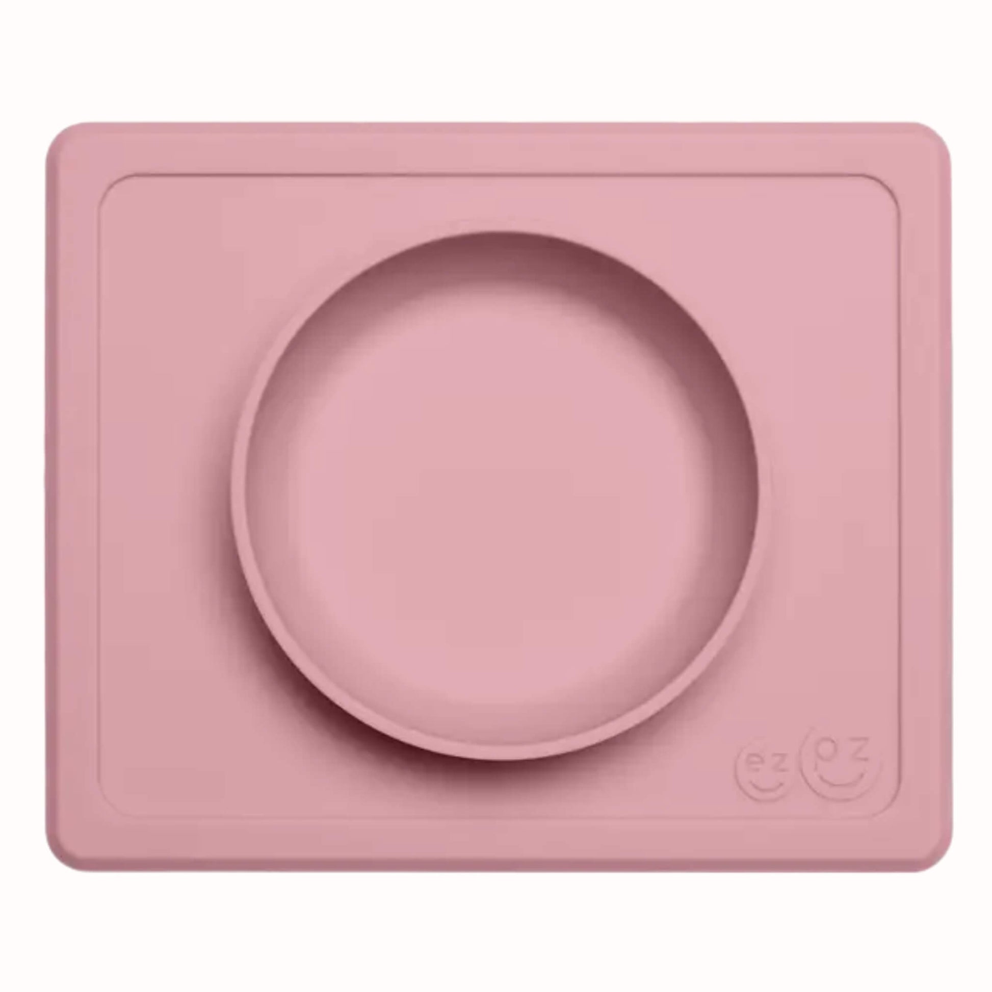Blush silicone suction bowl with matching rectangular placemat designed for toddler meals and snacks.