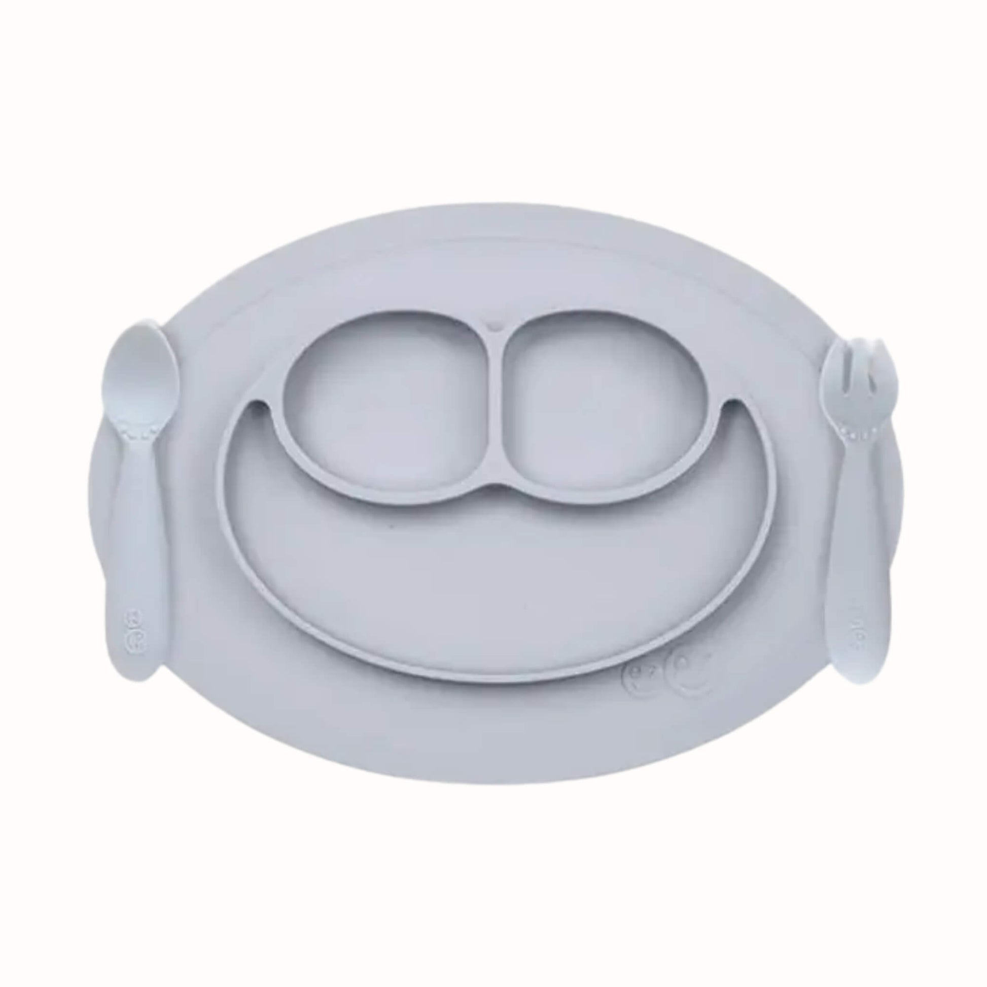 Silicone divided mini mat in pewter with matching spoon and fork placed on either side for toddler self-feeding.