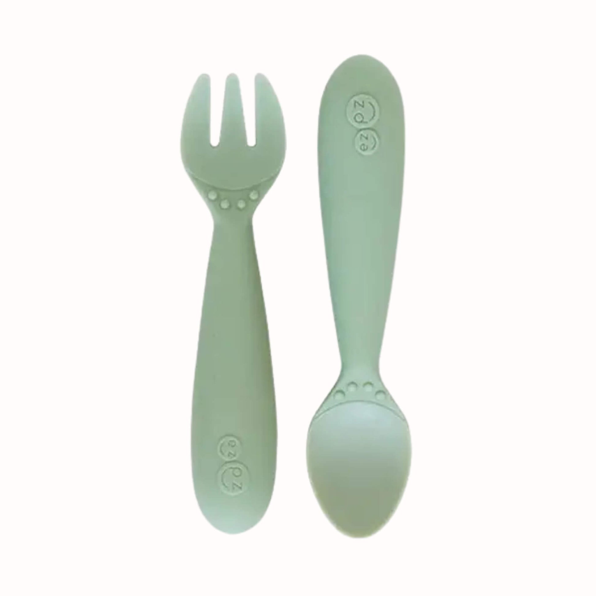 Sage silicone toddler fork and spoon with chunky handles sized for smaller hands.