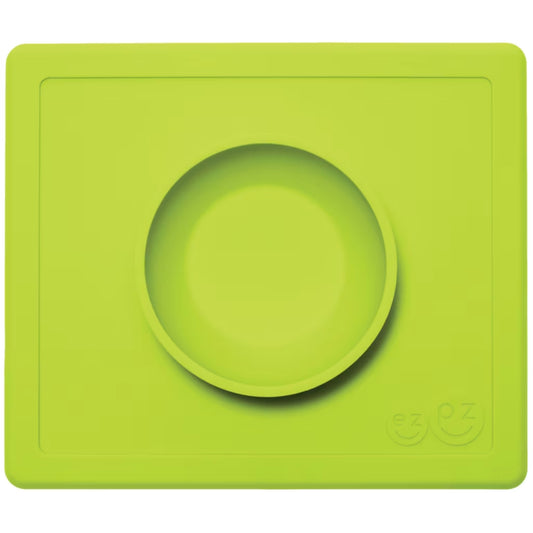 ezpz Happy Bowl in lime. A round silicone bowl is built into a rectangular placemat with the ezpz smiley face logo embossed in the corner.