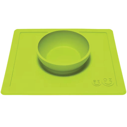 Lime silicone bowl attached to a flat rectangular placemat, shown from an angle to highlight the depth of the bowl.
