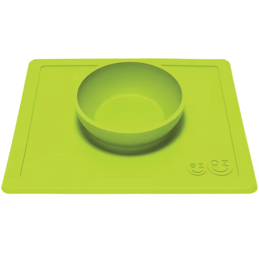 Lime silicone bowl attached to a flat rectangular placemat, shown from an angle to highlight the depth of the bowl.
