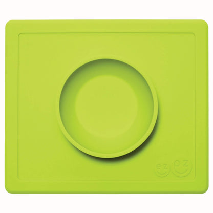 Lime green suction bowl placed in the centre of a matching rectangular silicone placemat.