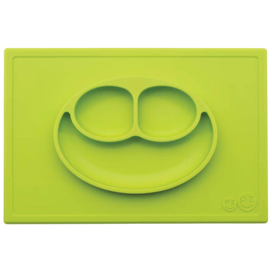 Ezpz Happy Mat in lime green, a silicone placemat and plate in one with three compartments in a smiley face design for toddler mealtimes.