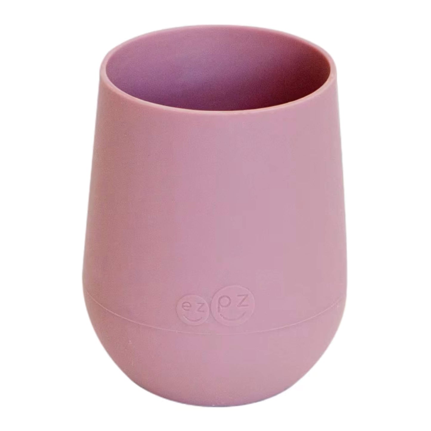 Ezpz Mini Cup in blush pink, made from soft silicone with a non-slip base, designed as a toddler training cup for open cup drinking.