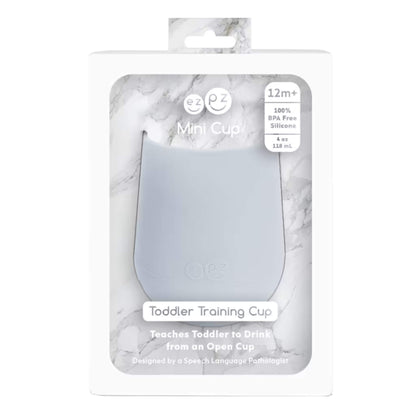A retail box containing a pewter silicone mini training cup, labelled as BPA free and suitable for toddlers aged 12 months and older.