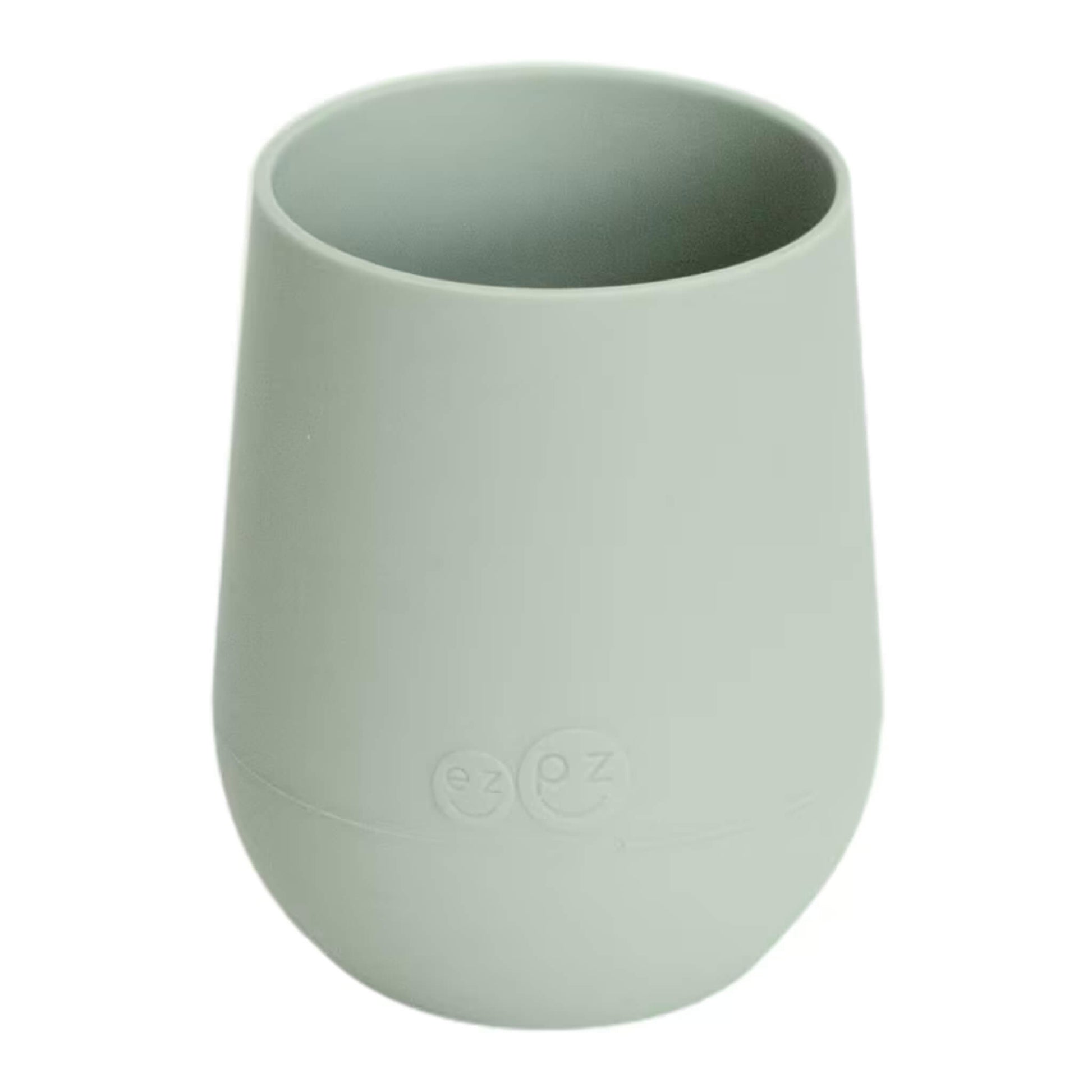 Ezpz Mini Cup in sage green, made from soft silicone with a non-slip base, designed as a toddler training cup for open cup drinking.