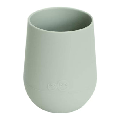 Ezpz Mini Cup in sage green, made from soft silicone with a non-slip base, designed as a toddler training cup for open cup drinking.