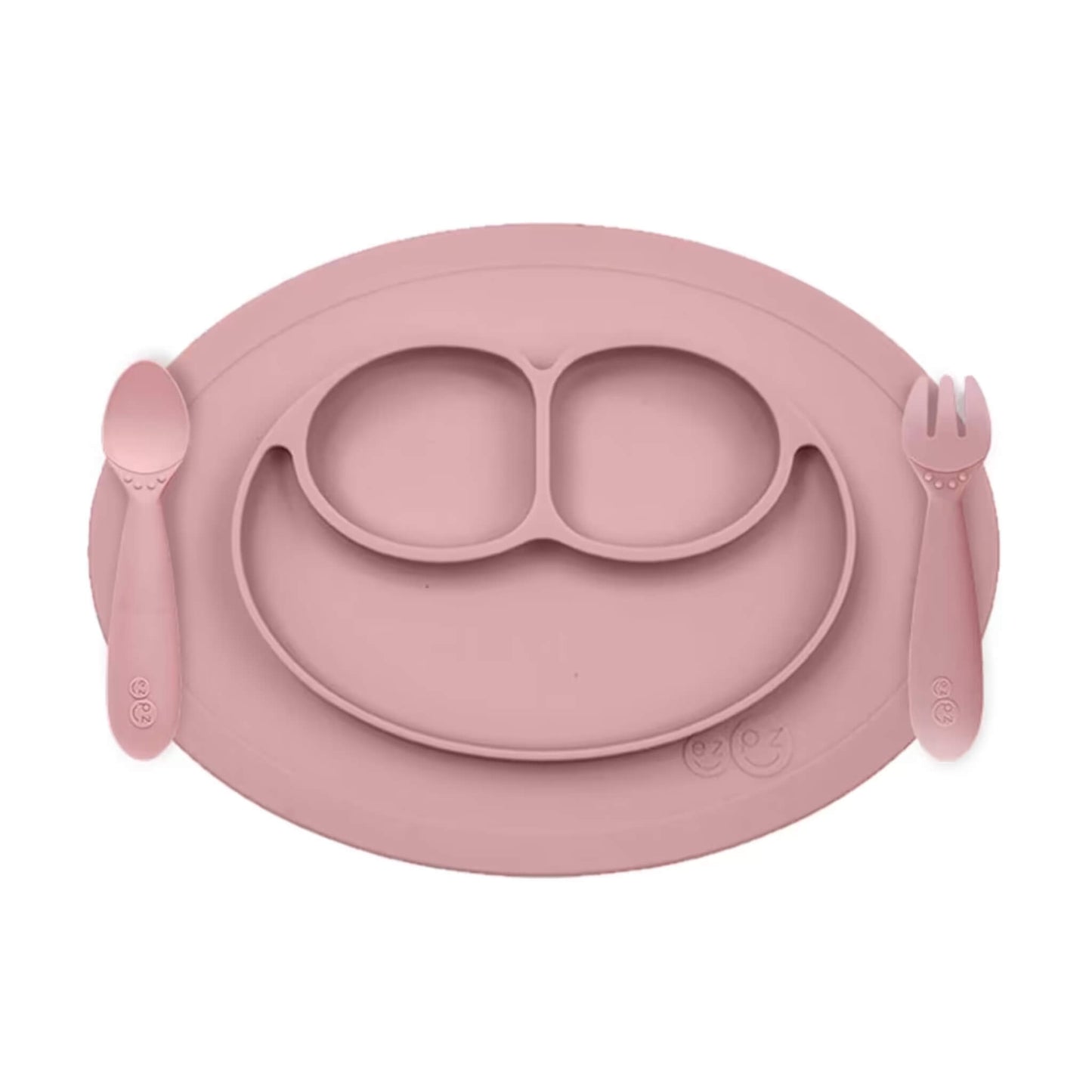 ezpz Mini Feeding Set in Blush silicone with suction placemat, divided smiley plate, toddler spoon and fork.
