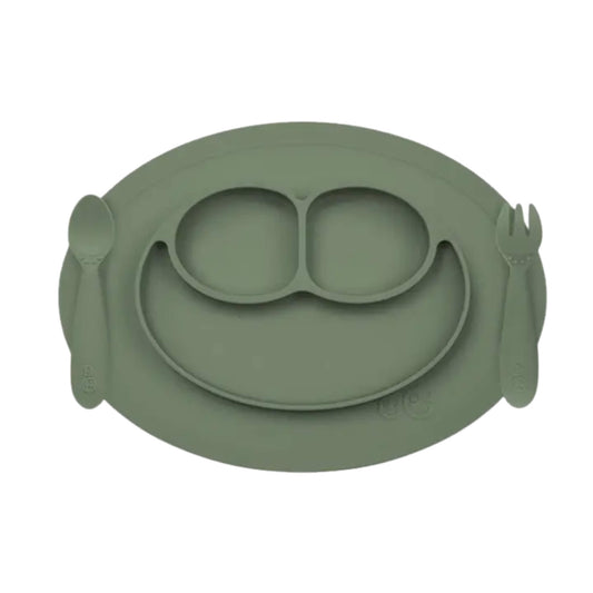 ezpz Mini Feeding Set in Blush silicone with suction placemat, divided smiley plate, toddler spoon and fork.
