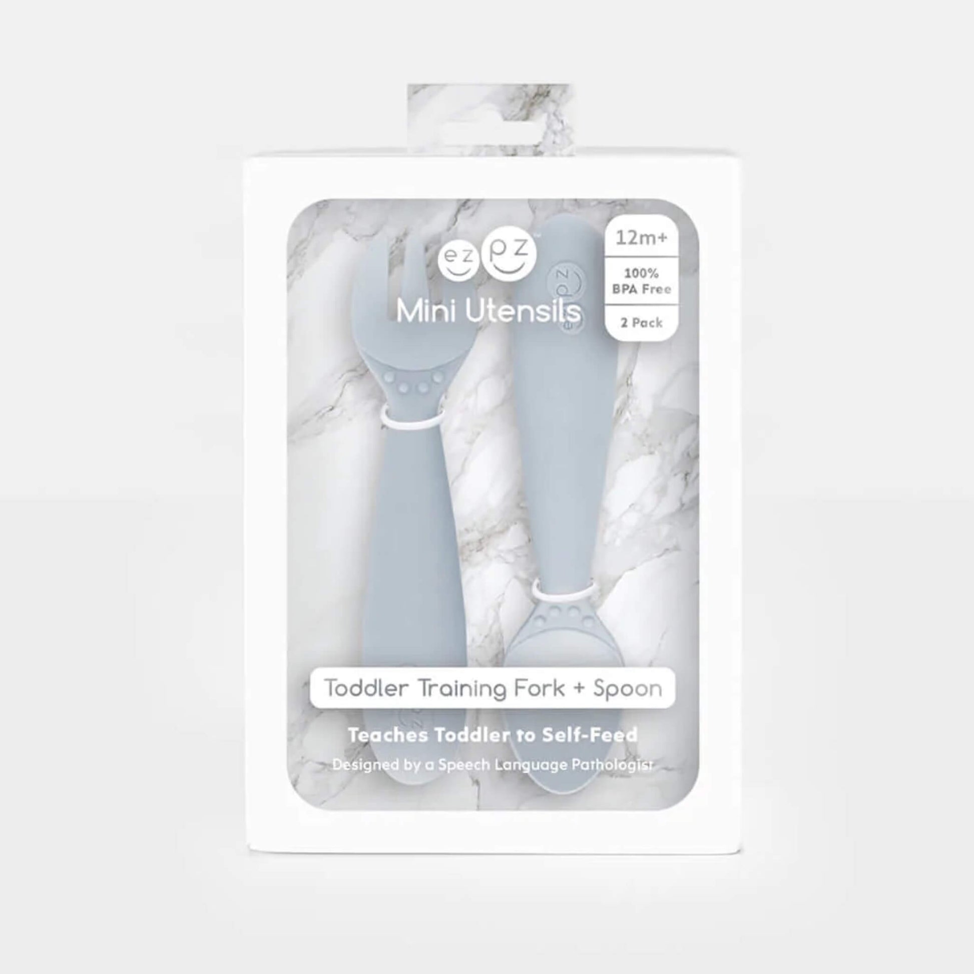 Boxed set of Ezpz Mini Utensils in pewter grey showing a toddler training fork and spoon displayed in retail packaging.
