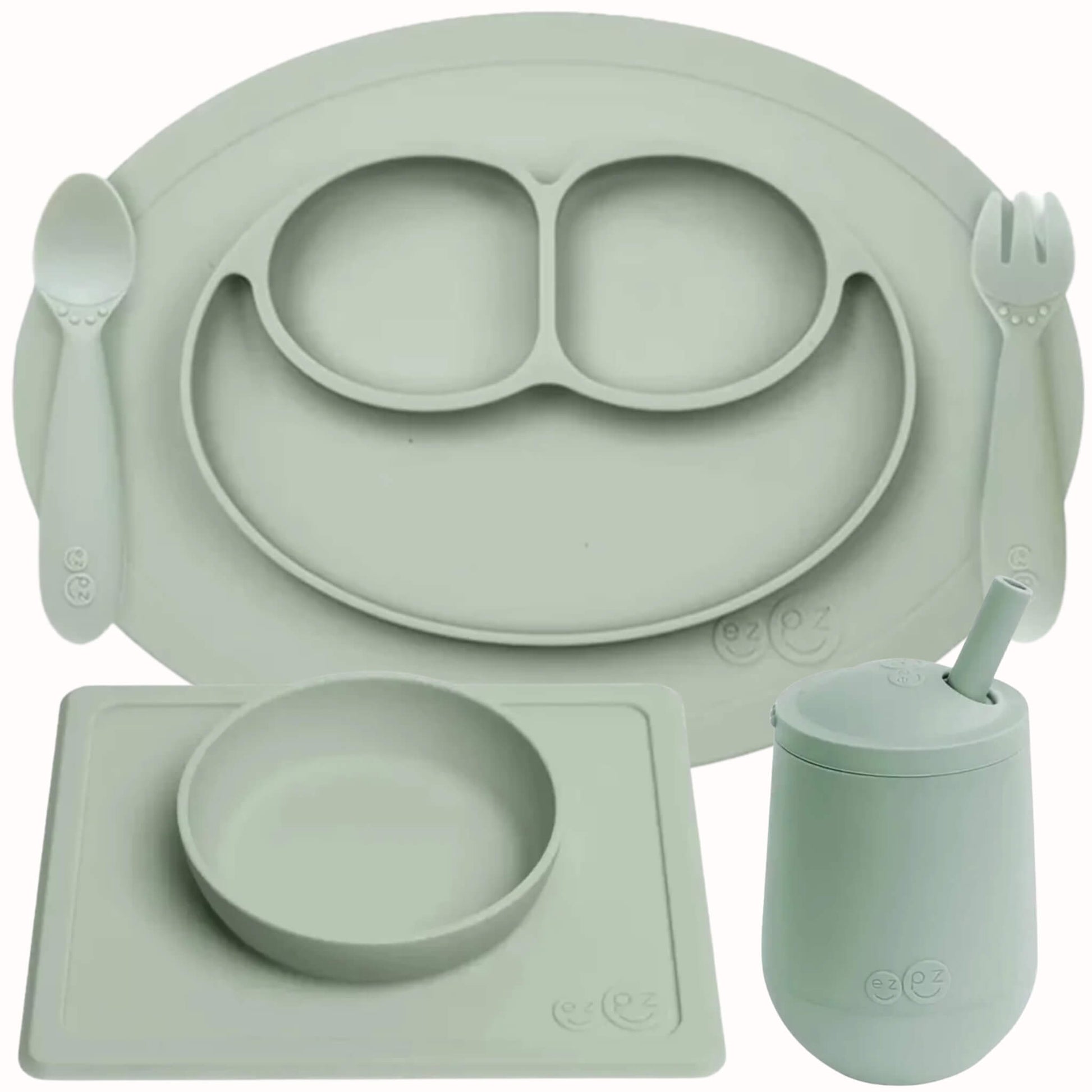 ezpz Self-Feeding Mealtime Bundle in sage featuring a silicone mini mat, spoon, fork, suction bowl with placemat and mini cup with straw.