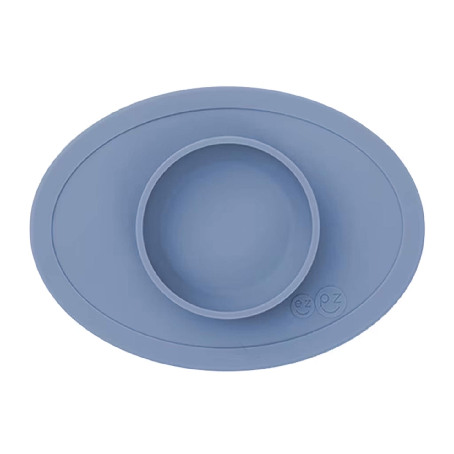 Ezpz Tiny Bowl in indigo, a silicone suction placemat with a built-in round bowl, shown empty against a plain background.