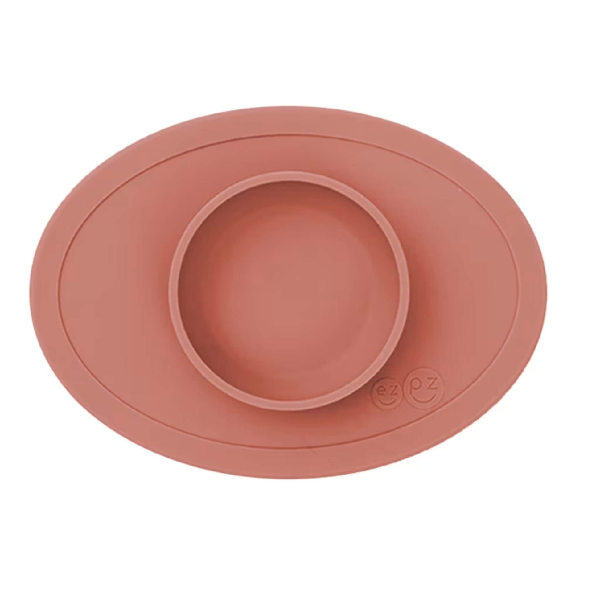 Ezpz Tiny Bowl in sienna colour, a silicone suction placemat with a built-in round bowl, shown empty against a plain background.
