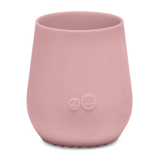 ezpz Tiny Cup in blush pink shown from the front with a smooth tapered shape and subtle embossed logo on the centre.