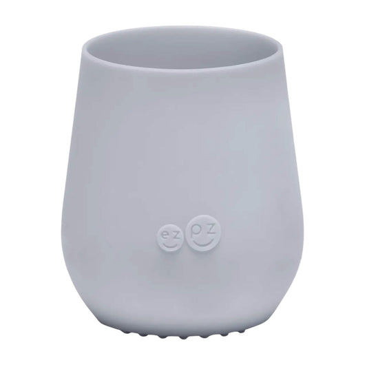 ezpz Tiny Cup in pewter grey shown from the front with a smooth tapered shape and subtle embossed logo on the centre.