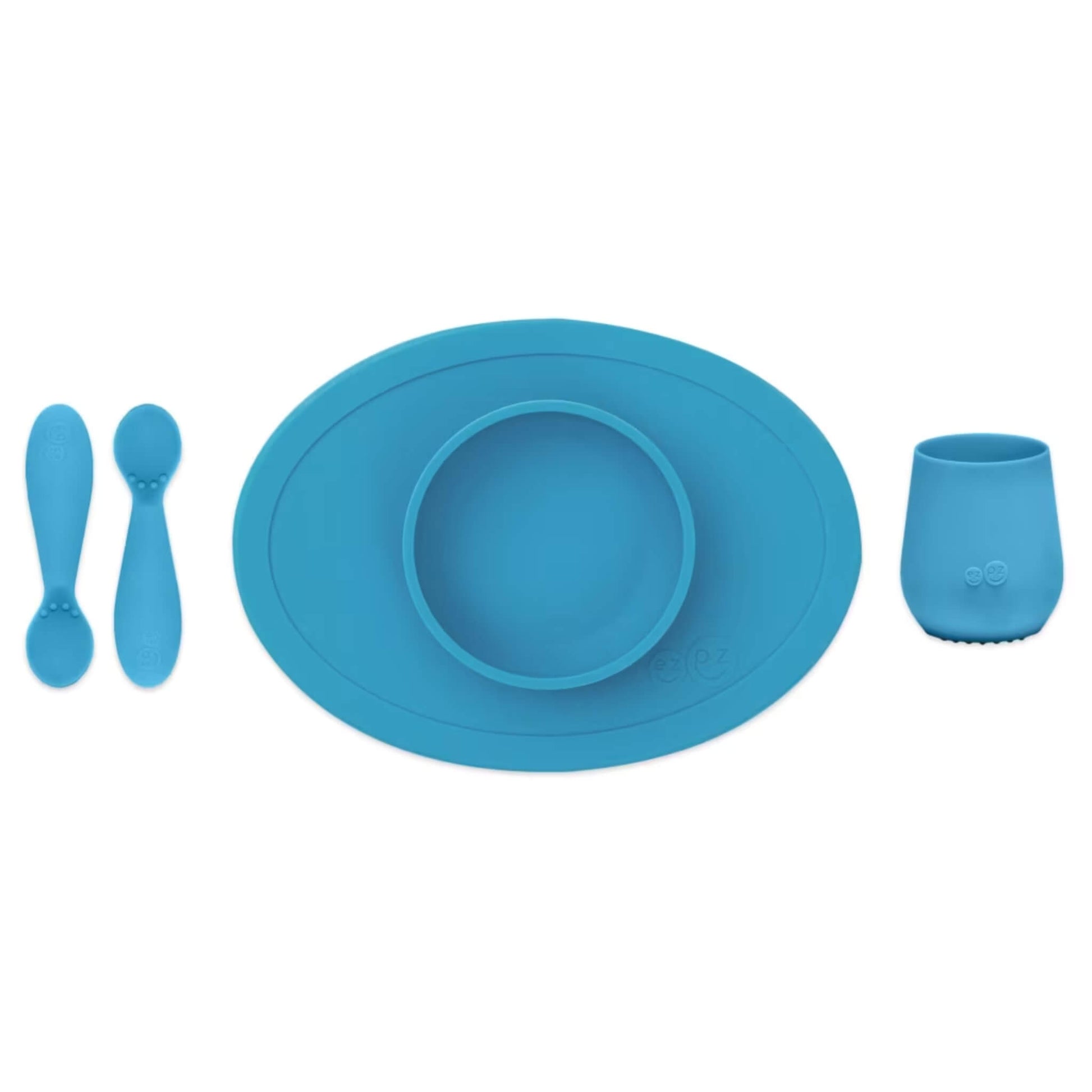 Ezpz Tiny First Foods Set in Blue with two silicone training spoons, a suction bowl and an open cup designed for baby weaning.