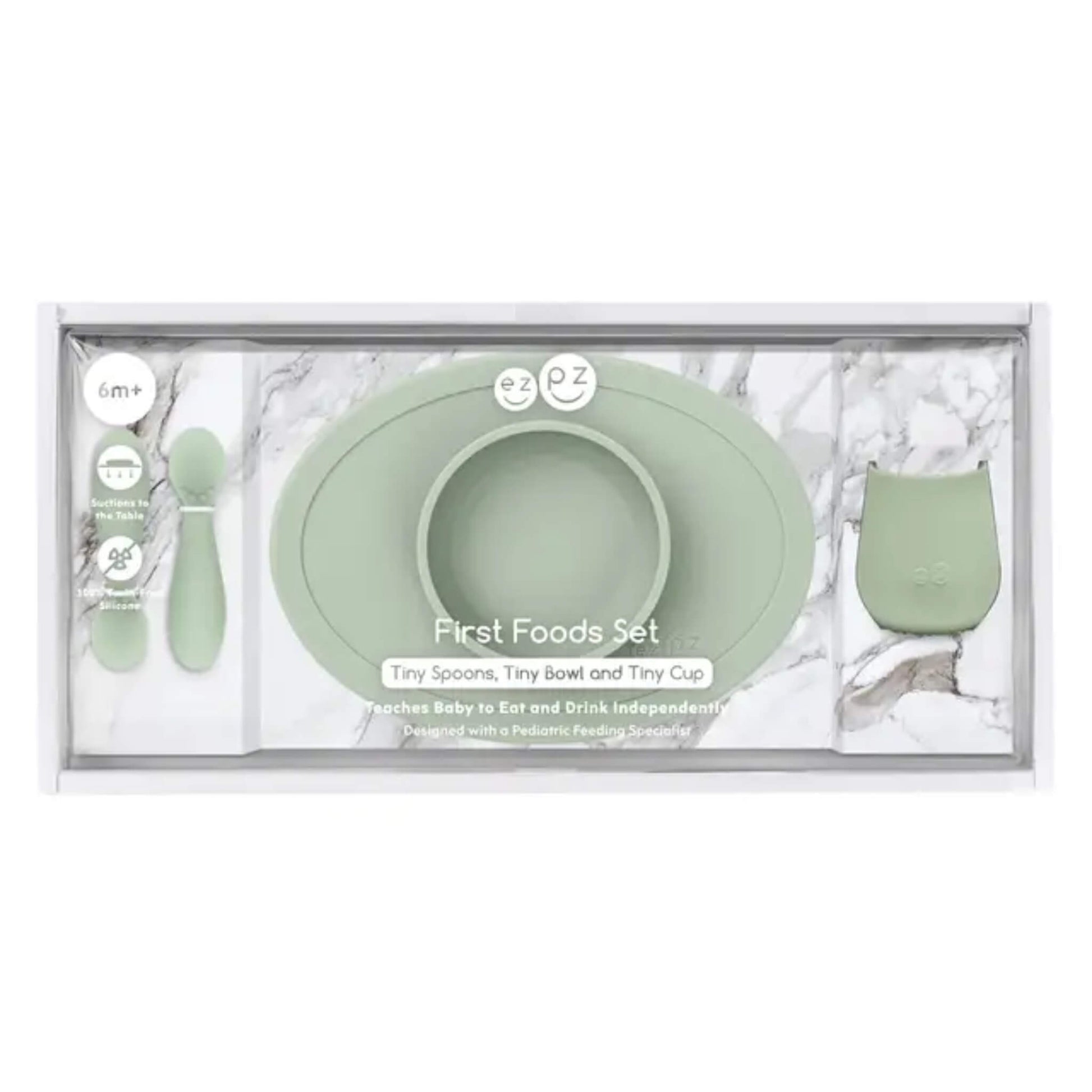 First foods baby weaning set in sage green featuring a suction bowl, open cup and two soft silicone spoons for babies learning to self-feed.