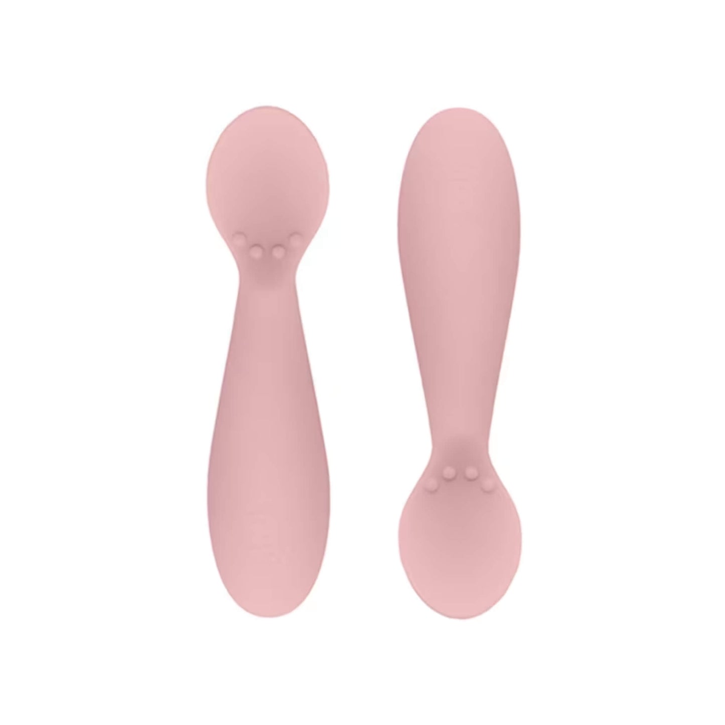 Ezpz Tiny Spoons in blush pink, a pair of silicone infant training spoons with shallow heads and textured bumps near the base.