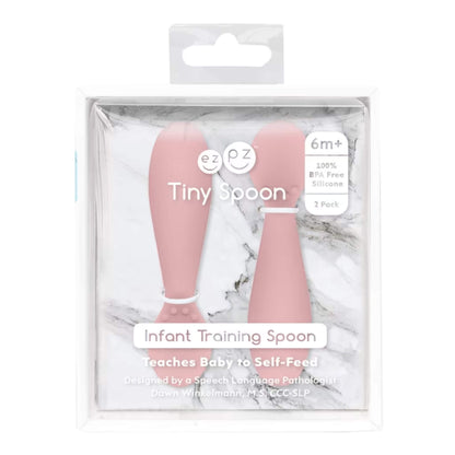 Retail packaging of Ezpz Tiny Spoons two-pack in blush pink, labelled “Infant Training Spoon” with product details on clear display box.