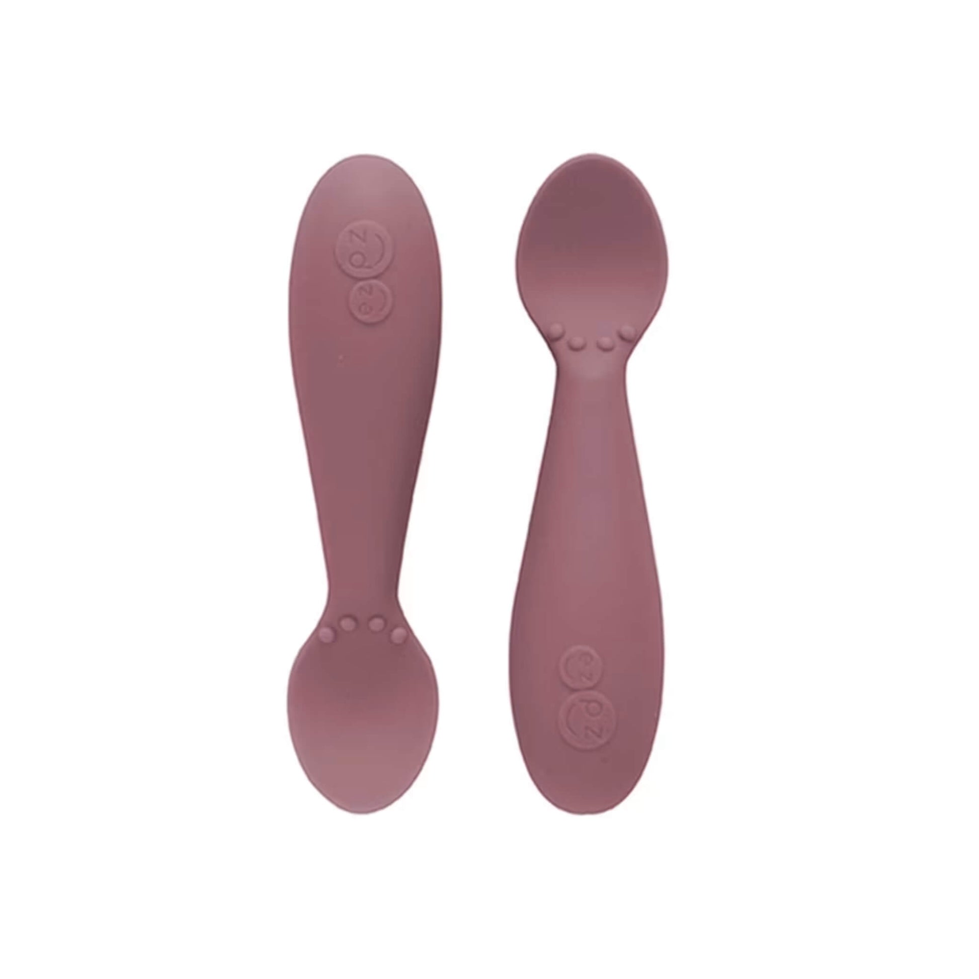 Ezpz Tiny Spoons in mauve, a pair of silicone infant training spoons with shallow heads and textured bumps near the base.