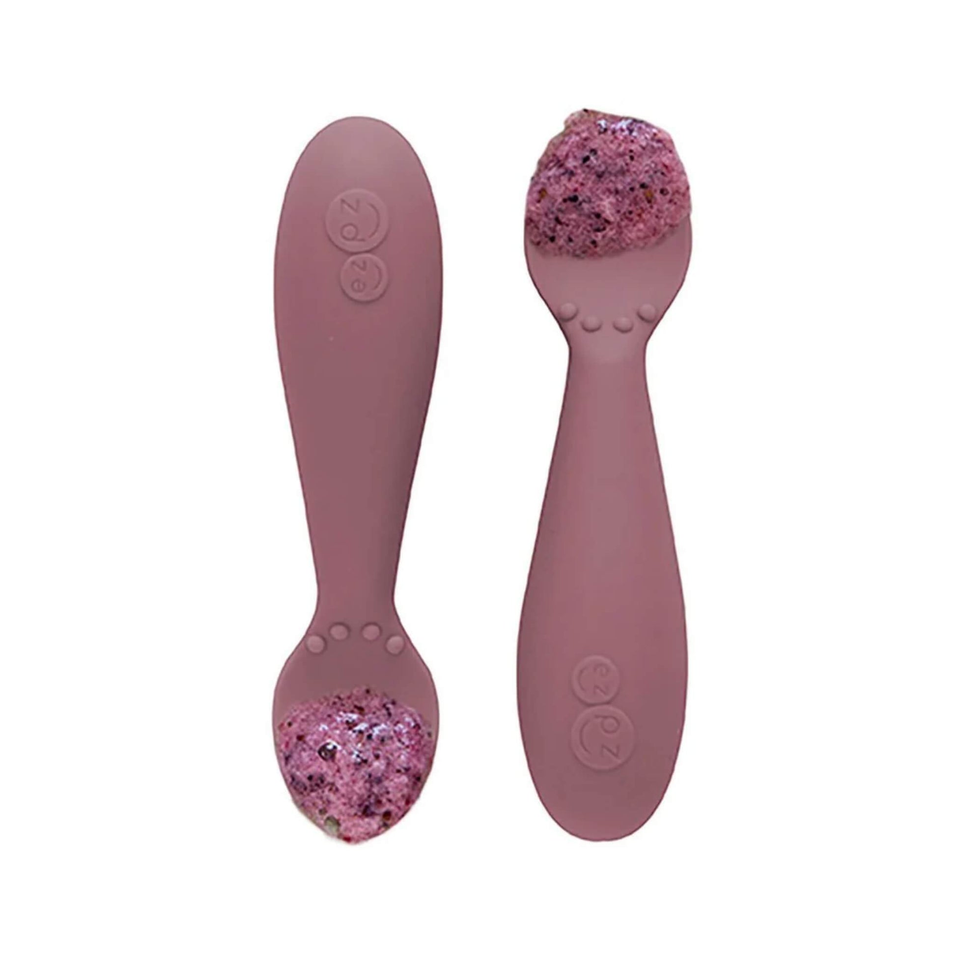 Pair of mauve silicone training spoons, each filled with a serving of purple baby food, shown close-up.