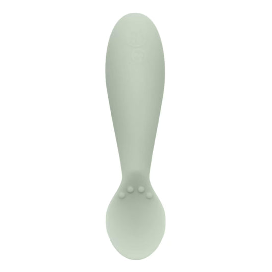Single sage green silicone infant training spoon with shallow head and small textured bumps on the handle.