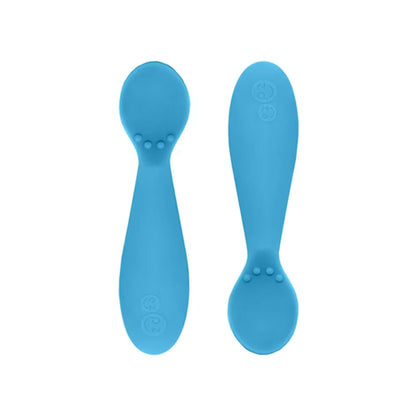 Ezpz Tiny Spoons in blue, a pair of infant training spoons made from soft silicone, shown front and back against a plain background.
