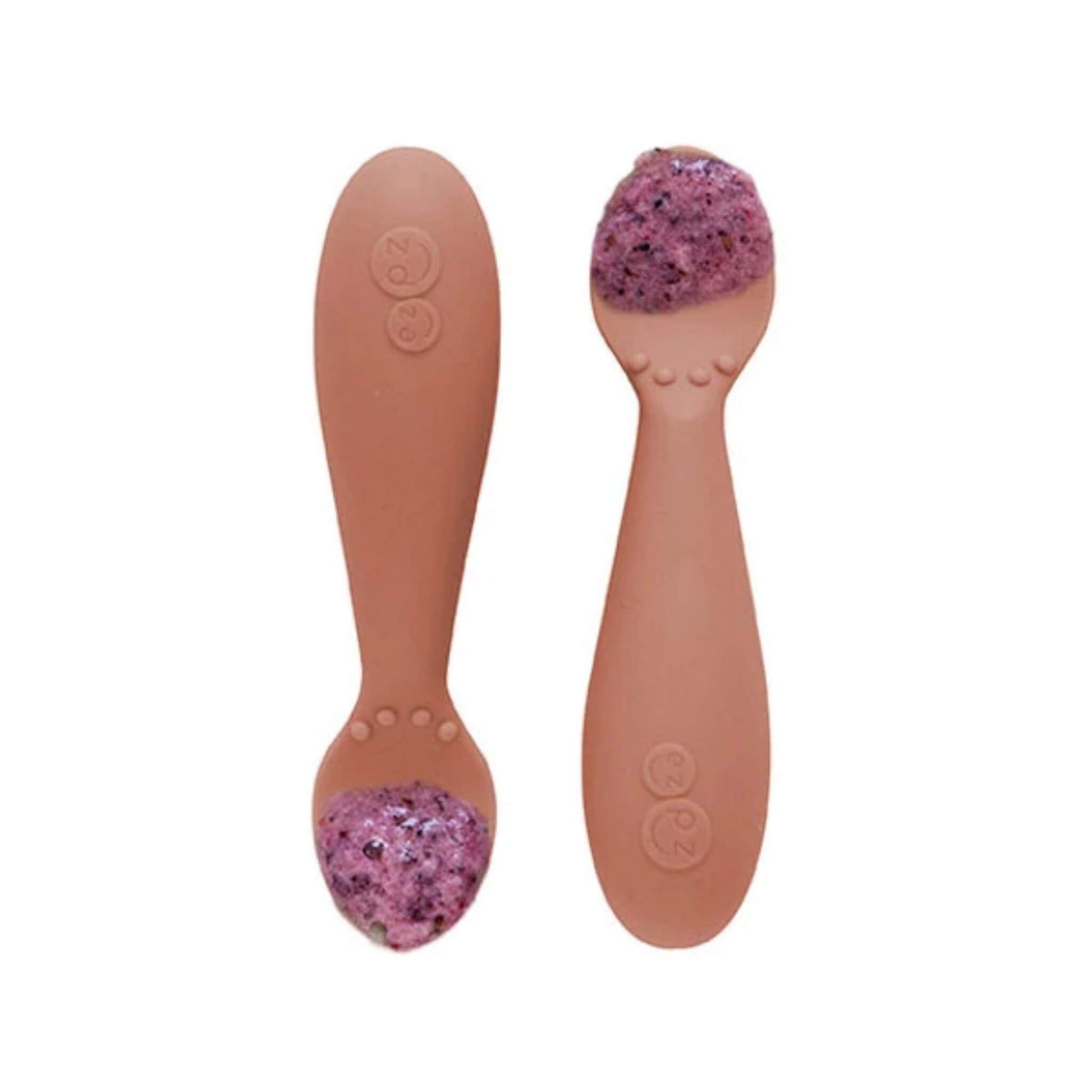 Pair of sienna silicone training spoons,  filled with a serving of purple baby food, shown close-up.