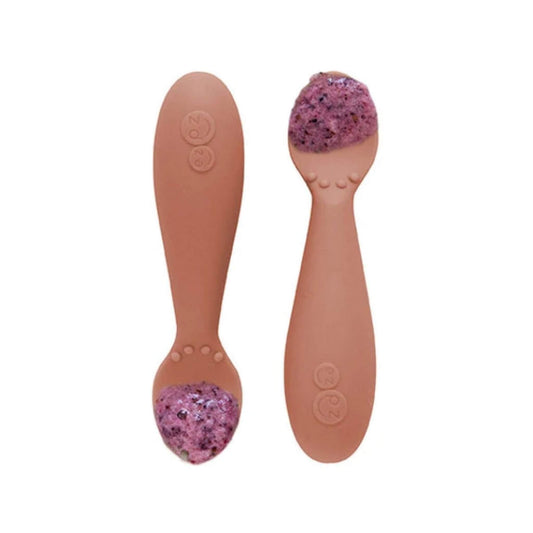 Pair of sienna silicone training spoons,  filled with a serving of purple baby food, shown close-up.