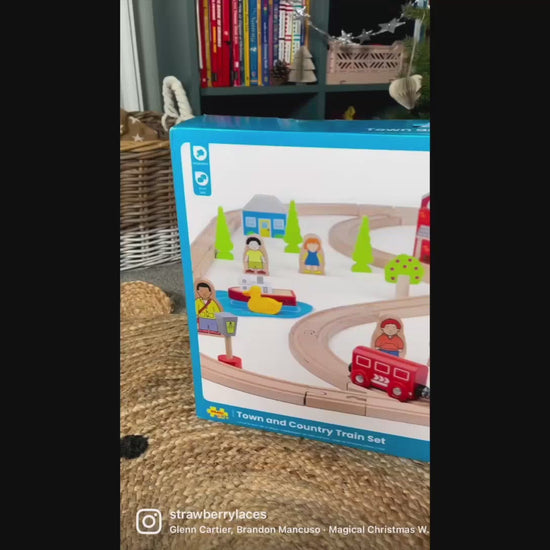 Video demonstration of the Bigjigs Toys Town & Country Train Set, showing children arranging the wooden track, pushing the colourful train, and exploring the town and countryside accessories through imaginative play.