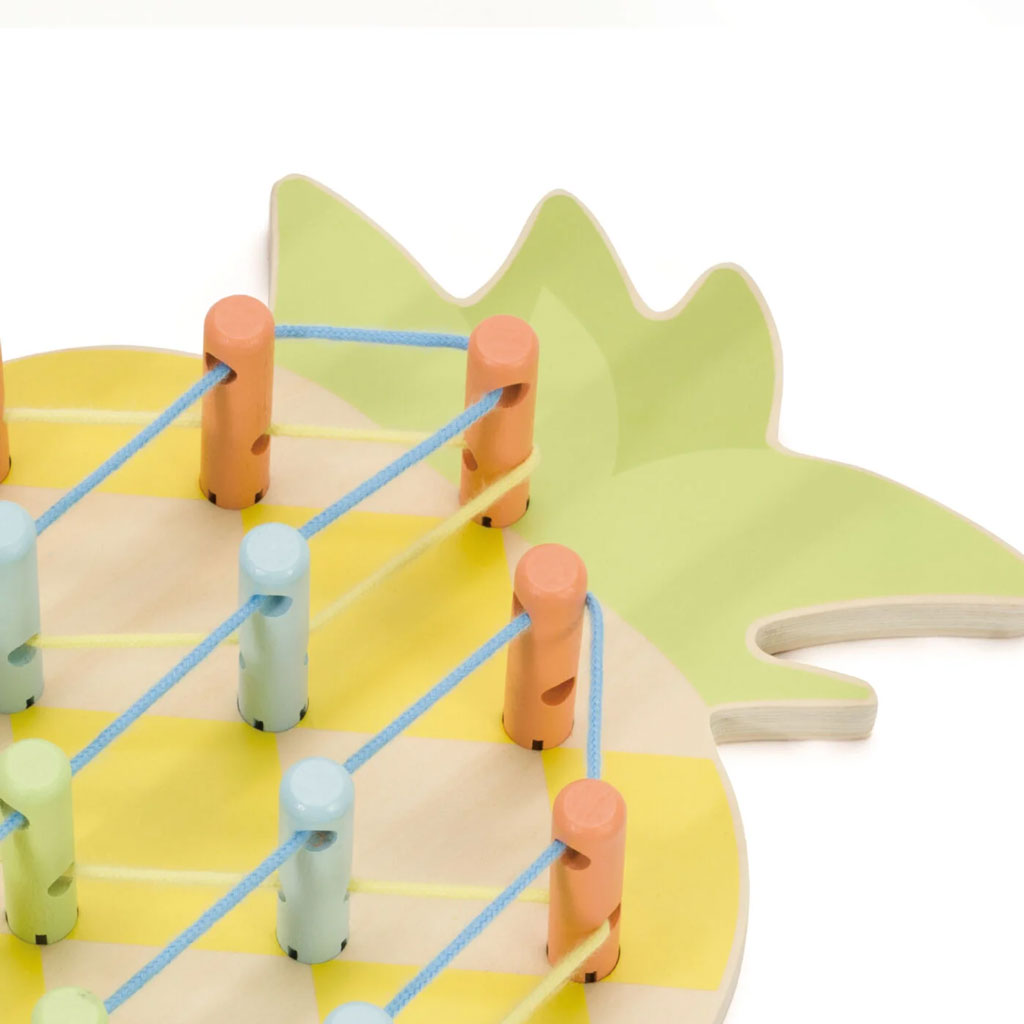 Close-up of a Pineapple Linking Game showcasing colourful pegs and threads creating a vibrant 3D pattern on a wooden base.