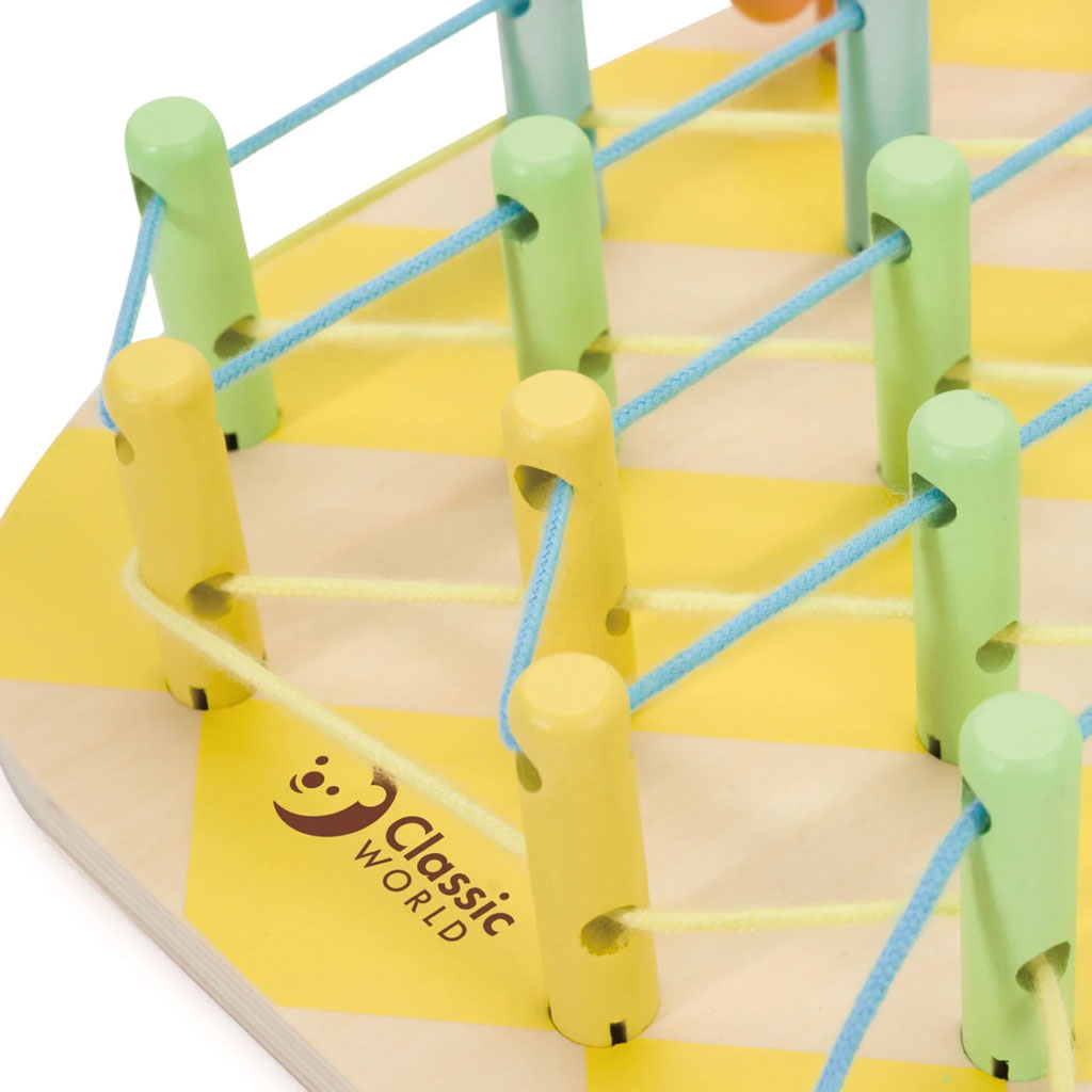 Close-up of the Classic World Pineapple Linking Game showing yellow and green pegs threaded with blue strings, highlighting its vibrant design.