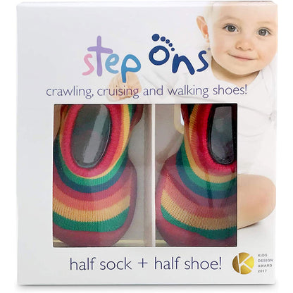 Retail packaging for Step Ons baby shoes, showing a white box with a clear window revealing rainbow stripe design shoes inside and printed product branding on the front.