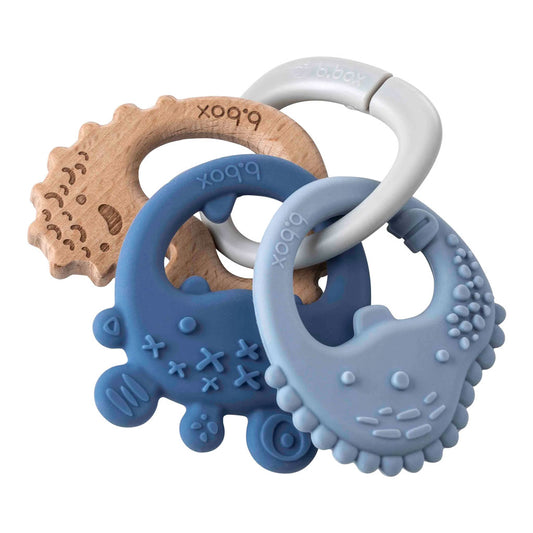 Designed to grow with baby the b.box trio teether has three textured teethers on one handy ring offering the choice of silicone and beechwood throughout the teething journey.  Lightweight and easy to hold, use individually or as a set with customisable ring attachment to provide relief to sore, achy gums and stimulate sensory development.